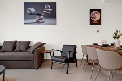 a living room with a couch and a table and chairs at CanalFront - Central Location up to 7 Guests in Dubai