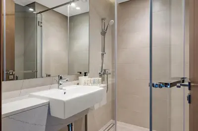 a bathroom with a sink and a shower at CanalFront - Central Location up to 7 Guests in Dubai