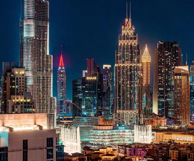 a view of a large city at night at Elite Royal Apartment - Panoramic Burj Khalifa View - Sky Edition - Luxurious - Zacharyas in Dubai