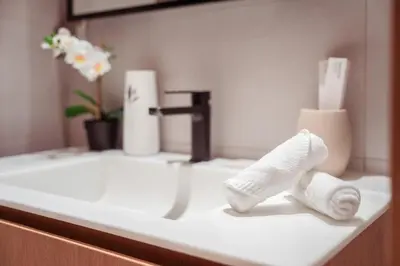 a bathroom sink with two rolls of toilet paper on it at Elite Royal Apartment - Panoramic Burj Khalifa View - Sky Edition - Luxurious - Zacharyas in Dubai