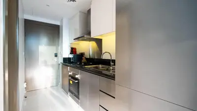 a kitchen with a sink and a counter top at Keyrock Damac Maison Privée - Studio in Business Bay with Pool, Gym & Free Parking in Dubai