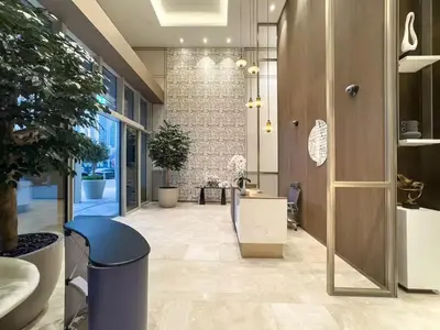 an office with a hallway with potted plants at Stunning 1BR Burj View from Infinity Pool in Dubai