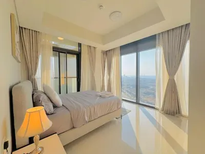 a bedroom with a bed and a large window at 2 Bedroom Fully Furnished- Aykon City Tower C in Dubai