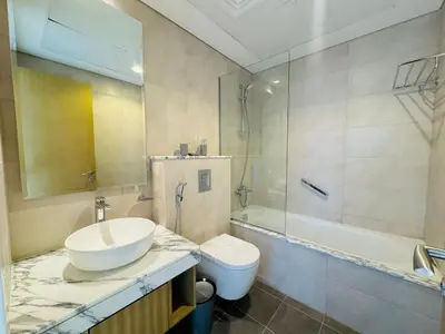 a bathroom with a sink and a tub and a toilet at 2 Bedroom Fully Furnished- Aykon City Tower C in Dubai