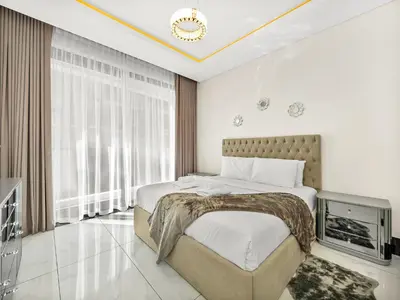 a bedroom with a large bed and a tv at Huge Lux 1BHK in Prime Business Bay with Private Jacuzzi in Dubai