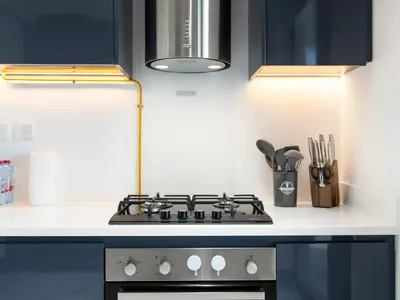 a kitchen with a stove top oven next to a counter at Huge Lux 1BHK in Prime Business Bay with Private Jacuzzi in Dubai