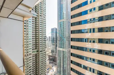 a view of tall buildings in a city at Upgraded 2BR with Partial Sea View Near to Dubai Tram, Elite Residence, Dubai Marina by Deluxe Holiday Homes in Dubai