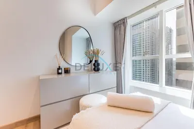 a dressing room with a mirror and a window at Upgraded 2BR with Partial Sea View Near to Dubai Tram, Elite Residence, Dubai Marina by Deluxe Holiday Homes in Dubai