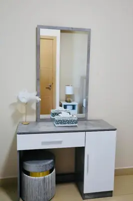 a dressing table with a mirror and a stool at Nivis find-Burj Vista-Direct access to Dubai mall in Dubai
