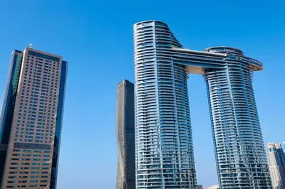 two tall buildings in a city with a blue sky at Nivis find-Burj Vista-Direct access to Dubai mall in Dubai