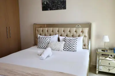 a bedroom with a white teddy bear sitting on a bed at Nivis find-Burj Vista-Direct access to Dubai mall in Dubai