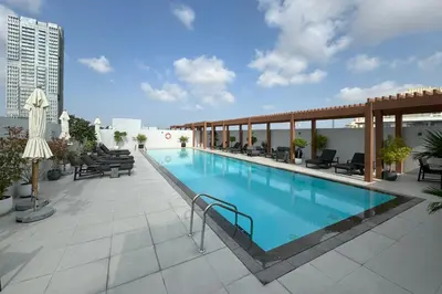 a swimming pool on the roof of a building at Luma Studio in Jumeirah Village Circle in Dubai