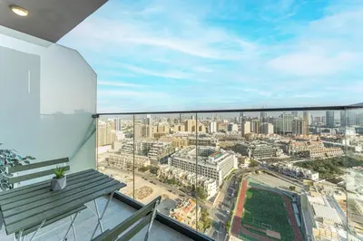 a balcony with a view of a city at HAVN - New Studio Apartment in Bloom Towers, JVC in Dubai