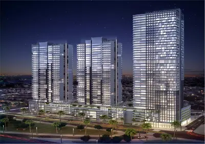 a group of tall buildings in a city at night at HAVN - New Studio Apartment in Bloom Towers, JVC in Dubai