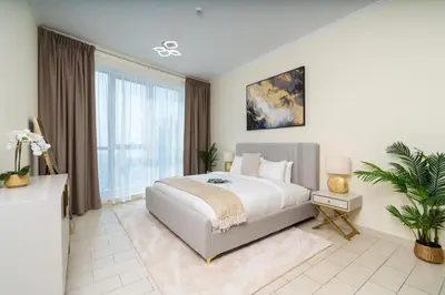 a bedroom with a large bed and a large window at Classy Upgraded High Floor Prime Location in Dubai