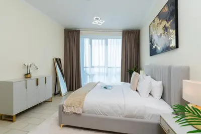 a bedroom with a large bed and a window at Classy Upgraded High Floor Prime Location in Dubai