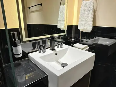 a bathroom with a white sink and a mirror at Bright Studio Burj Khalifa & Canal Views Pool in Dubai
