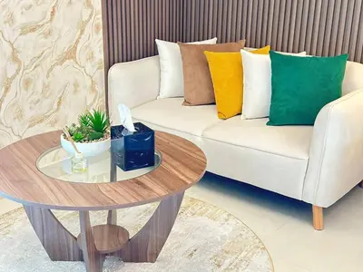 a living room with a couch and a table at Bright Studio Burj Khalifa & Canal Views Pool in Dubai