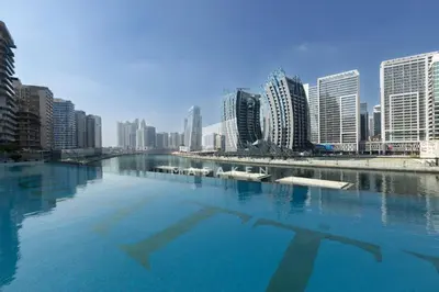 a large body of water in a city with buildings at Bright Studio Burj Khalifa & Canal Views Pool in Dubai