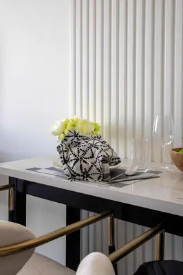 a table with a plate with a vase on it at Frank Porter - Samana Golf Avenue in Dubai