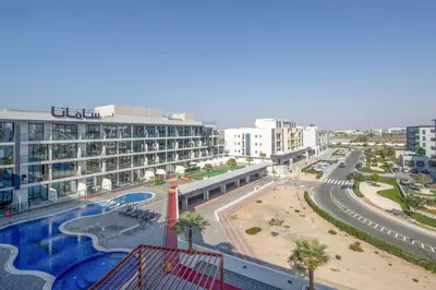 an overhead view of a city with a large building at Frank Porter - Samana Golf Avenue in Dubai