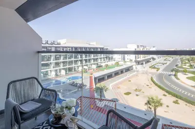 a balcony with a view of a large building at Frank Porter - Samana Golf Avenue in Dubai