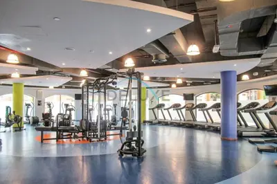a gym with a bunch of tread machines in it at Sea and Palm Jumeirah Views Just Steps from the Beach 2BR, Sadaf 6 , JBR by Deluxe Holiday Homes in Dubai