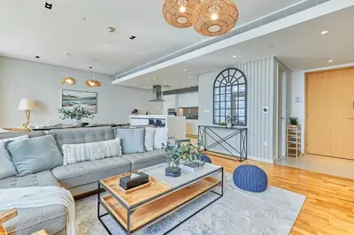 a living room with a couch and a table at Serene Seaside Stay - 2BR in Bluewaters with Sea View in Dubai