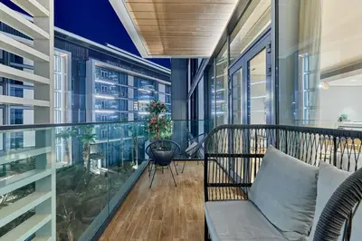 an apartment balcony with a couch and a table at Serene Seaside Stay - 2BR in Bluewaters with Sea View in Dubai