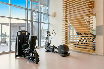 a gym with treadmills and exercise equipment in a building at Serene Seaside Stay - 2BR in Bluewaters with Sea View in Dubai