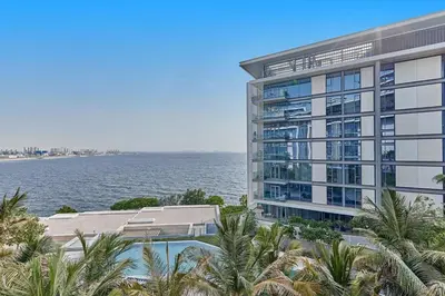 a large building next to a body of water at Serene Seaside Stay - 2BR in Bluewaters with Sea View in Dubai