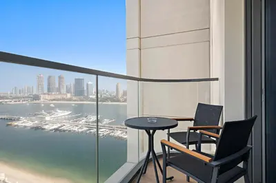 a table and two chairs on a balcony with a view at Silkhaus Waterfront 1BR in Marina Vista Tower in Dubai