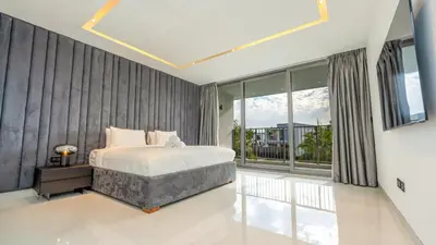 a bedroom with a bed and a large window at Lavish Sidra 3 Villa, 4BR plus M,Private Pool BBQ in Dubai