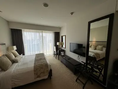 a hotel room with a bed and a large mirror at Stylish studio Located in JW Mariott Hotel Dubai Marina in Dubai