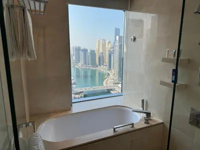 a bathroom with a bath tub and a window at Stylish studio Located in JW Mariott Hotel Dubai Marina in Dubai