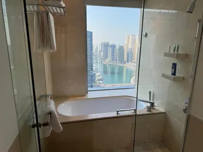 a bathroom with a bath tub and a window at Stylish studio Located in JW Mariott Hotel Dubai Marina in Dubai