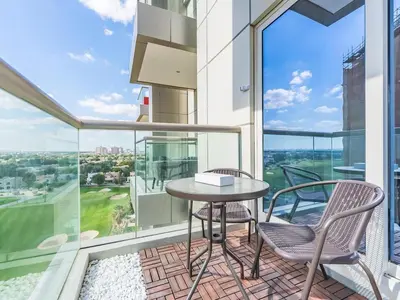 a balcony with a table and two chairs at Special Rate - Luxurious Studio - Golf View in Dubai