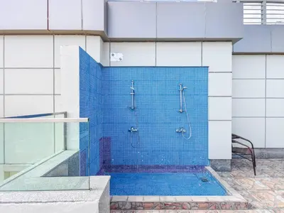 a shower in a building with a blue tiled wall at Special Rate - Luxurious Studio - Golf View in Dubai