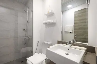 a bathroom with a sink and a toilet and a shower at Stylish 1-Bedroom Apartment with Premium Amenities in Dubai