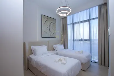 a hotel room with two beds and a window at Standard 2BHK located in Azizi riviera 46 in Dubai