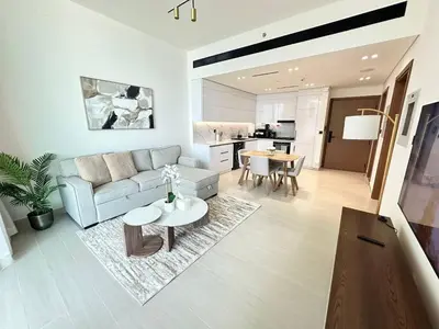 a living room with a couch and a table at Comfortable 1br Jvc Balcony Parking in Dubai