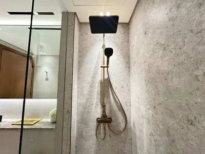 a shower in the corner of a bathroom at Comfortable 1br Jvc Balcony Parking in Dubai