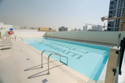 a swimming pool on the roof of a building at Comfortable 1br Jvc Balcony Parking in Dubai