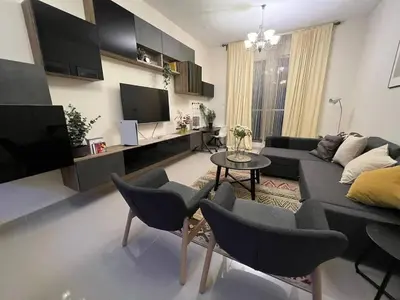 a living room with a couch and a table and chairs at Everything you need for a perfect Dubai Stay in Dubai
