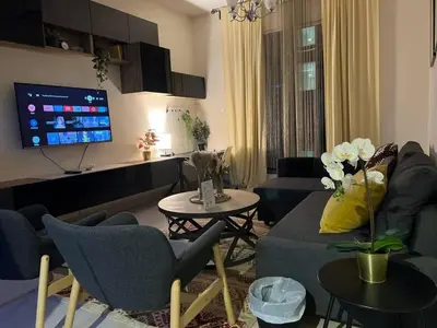 a living room with a couch and chairs and a tv at Everything you need for a perfect Dubai Stay in Dubai