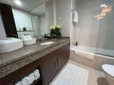 a bathroom with a sink and a toilet and a tub at Everything you need for a perfect Dubai Stay in Dubai