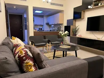 a living room with a couch and a table at Everything you need for a perfect Dubai Stay in Dubai