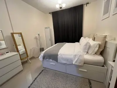 a bedroom with a bed with a dresser and a mirror at Everything you need for a perfect Dubai Stay in Dubai