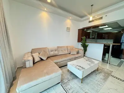 a living room with a couch and a coffee table at Opal Tower, Marina in Dubai