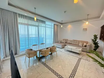 a living room with a table and chairs and a couch at Opal Tower, Marina in Dubai